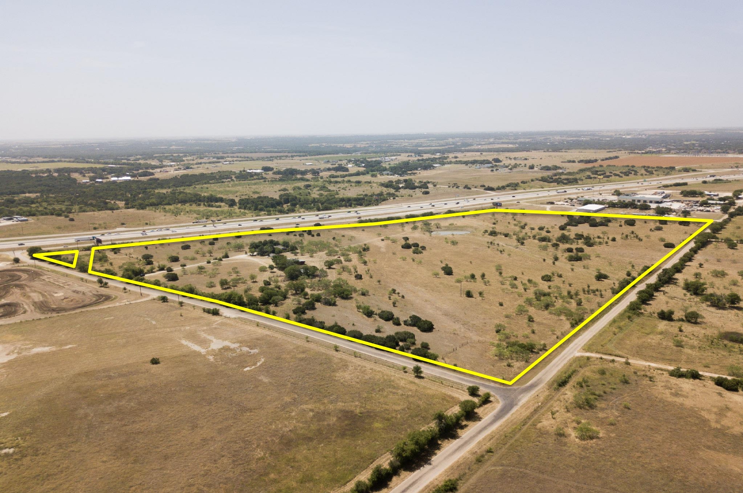 aerial view of the plot of land with yellow boundary line