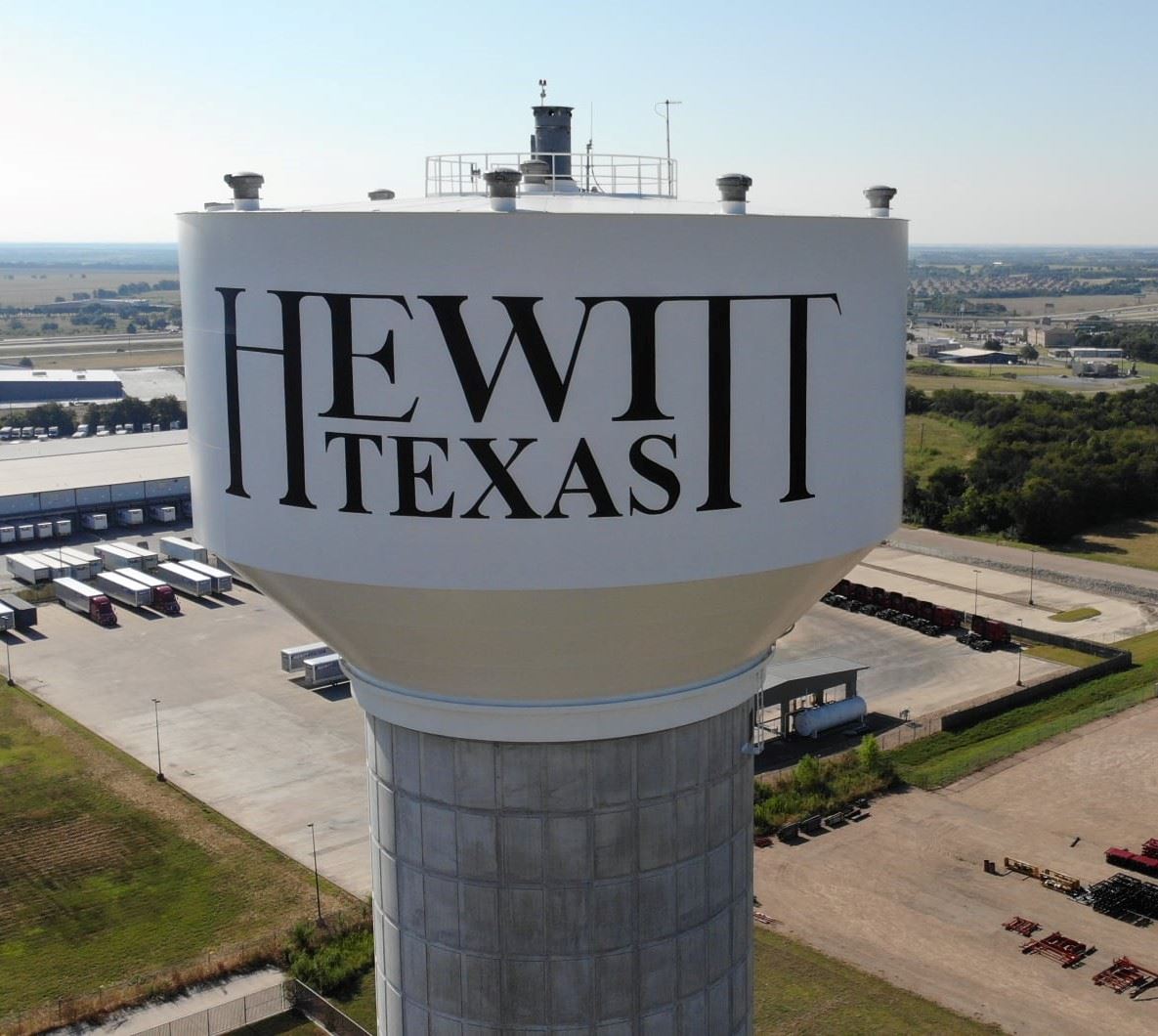 Hewitt, Texas water tower with the city in the background.